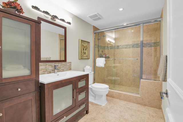 bathroom with walk in shower, tile patterned floors, backsplash, toilet, and vanity