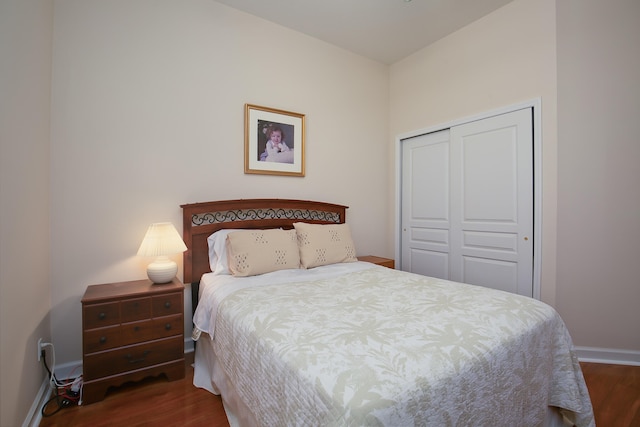 bedroom with a closet and dark hardwood / wood-style floors