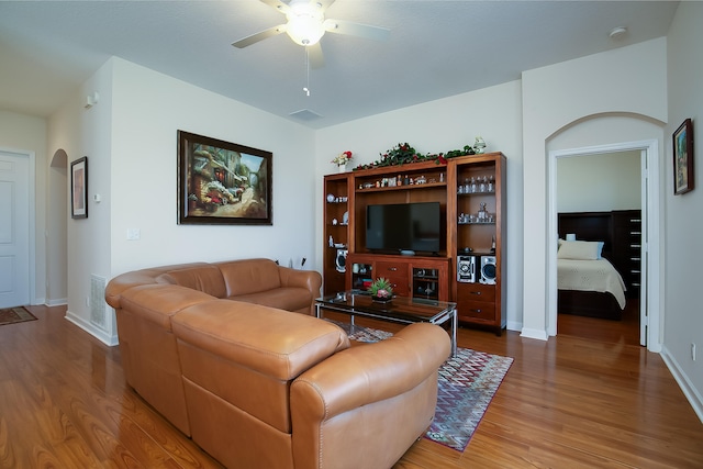 living room featuring ceiling fan and wood-type flooring