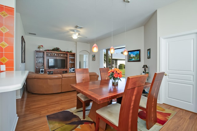 dining space featuring light wood-type flooring and ceiling fan