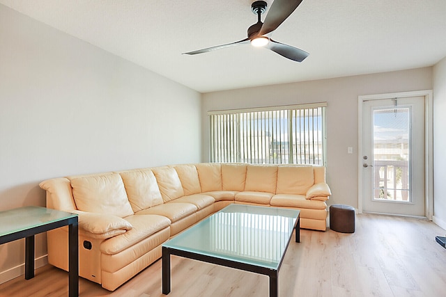 living room with light wood-type flooring and ceiling fan