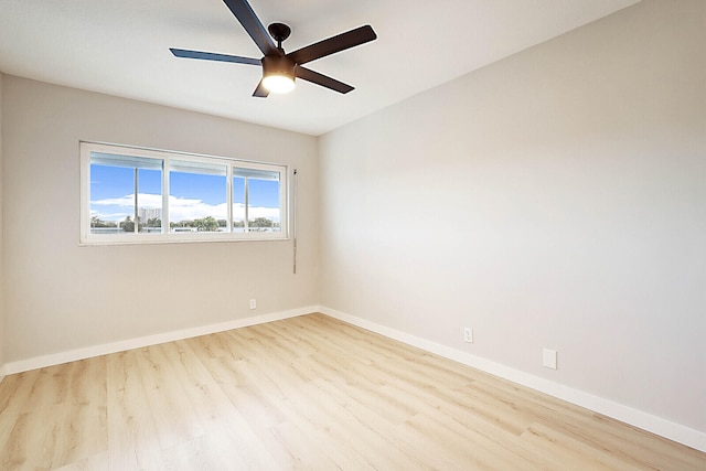 spare room featuring light hardwood / wood-style flooring and ceiling fan