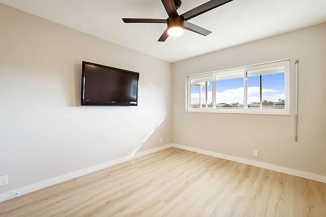 empty room with ceiling fan and light wood-type flooring