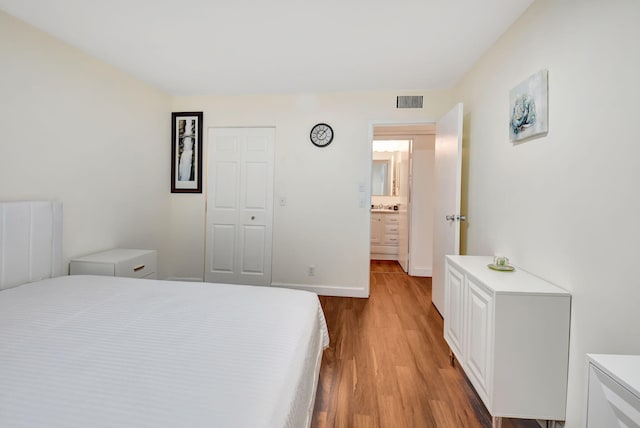 bedroom with a closet and light hardwood / wood-style flooring