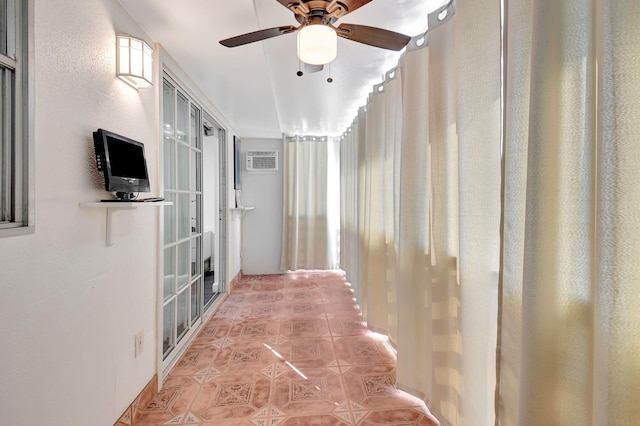 corridor with light tile patterned flooring and a wall mounted AC