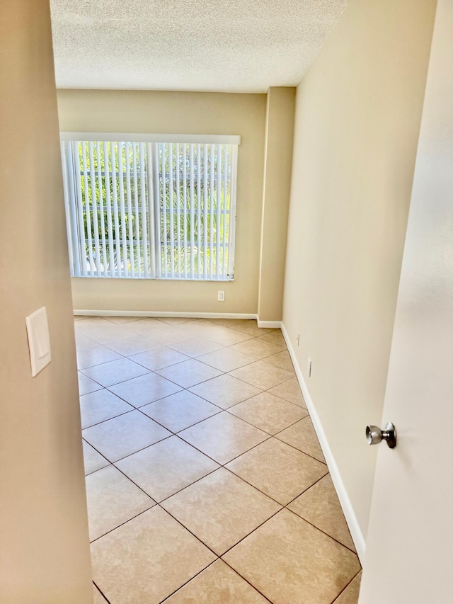 10777 W Sample Rd Unit 505, Coral Springs, FL 33065 - unfurnished room featuring light tile patterned flooring and a textured ceiling