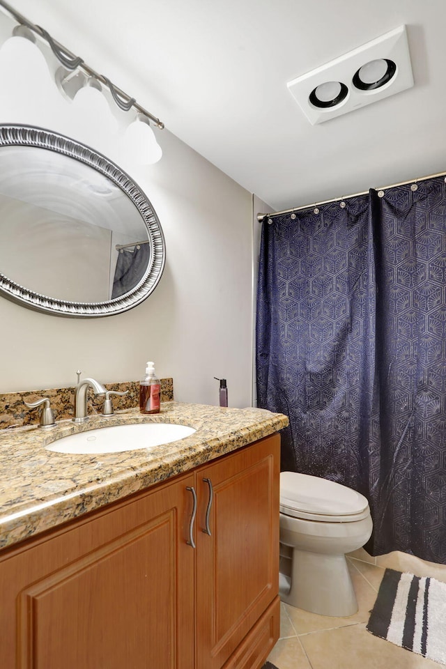 bathroom featuring tile patterned floors, vanity, and toilet