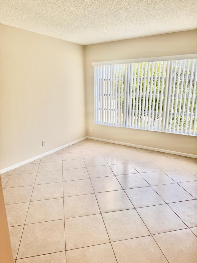 10777 W Sample Rd Unit 505, Coral Springs, FL 33065 - spare room featuring tile patterned floors and a textured ceiling