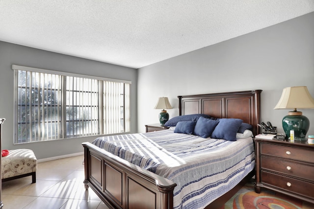 bedroom with light tile patterned flooring and a textured ceiling