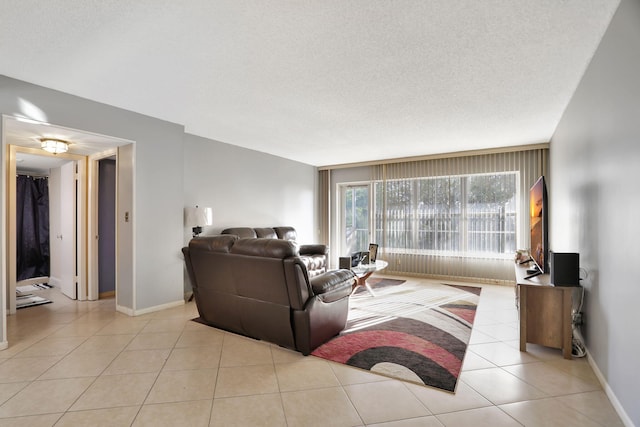 tiled living room featuring a textured ceiling