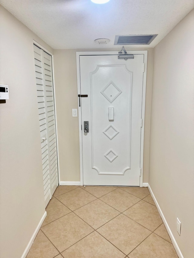 10777 W Sample Rd Unit 505, Coral Springs, FL 33065 - doorway featuring baseboards and light tile patterned floors