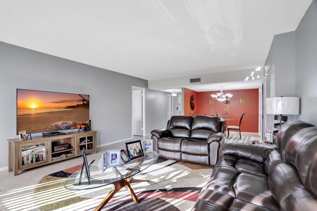 living room featuring light tile patterned floors and a chandelier