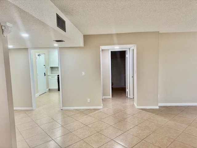 10777 W Sample Rd Unit 505, Coral Springs, FL 33065 - empty room with a textured ceiling and light tile patterned floors