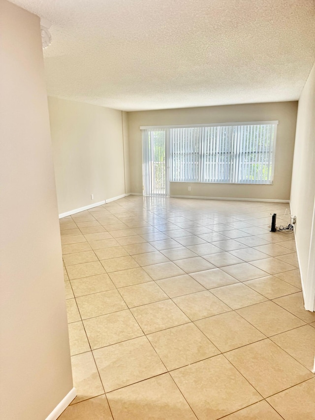 10777 W Sample Rd Unit 505, Coral Springs, FL 33065 - unfurnished room featuring light tile patterned flooring and a textured ceiling