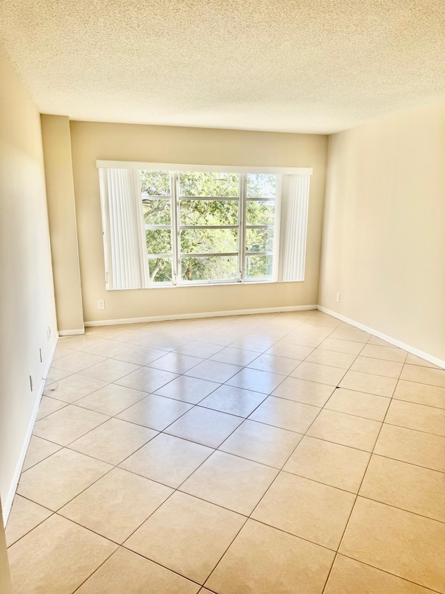 10777 W Sample Rd Unit 505, Coral Springs, FL 33065 - spare room featuring a textured ceiling and light tile patterned floors