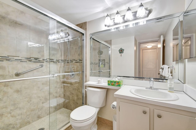 bathroom with toilet, vanity, and walk in shower