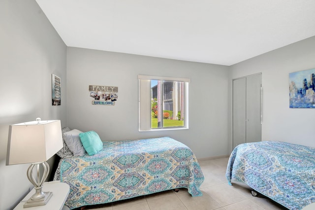 bedroom featuring a closet and light tile patterned floors