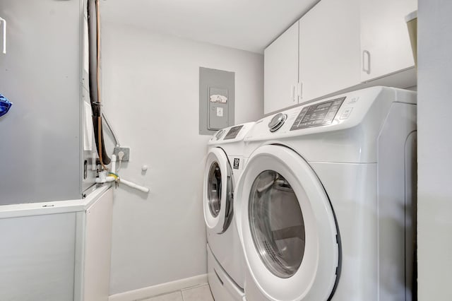 washroom featuring cabinets, washer and dryer, and light tile patterned floors