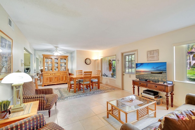 living room featuring light tile patterned floors and ceiling fan