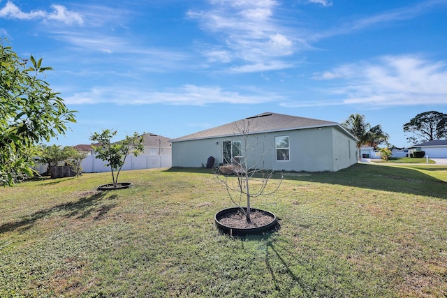 rear view of house with a yard