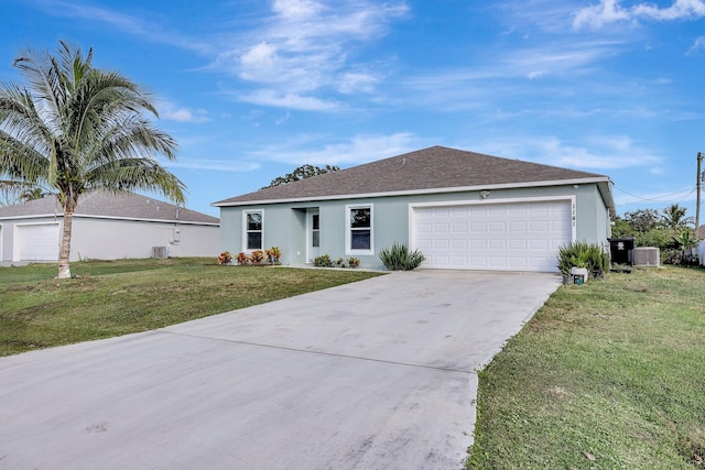 view of front of house with a front lawn, central AC unit, and a garage