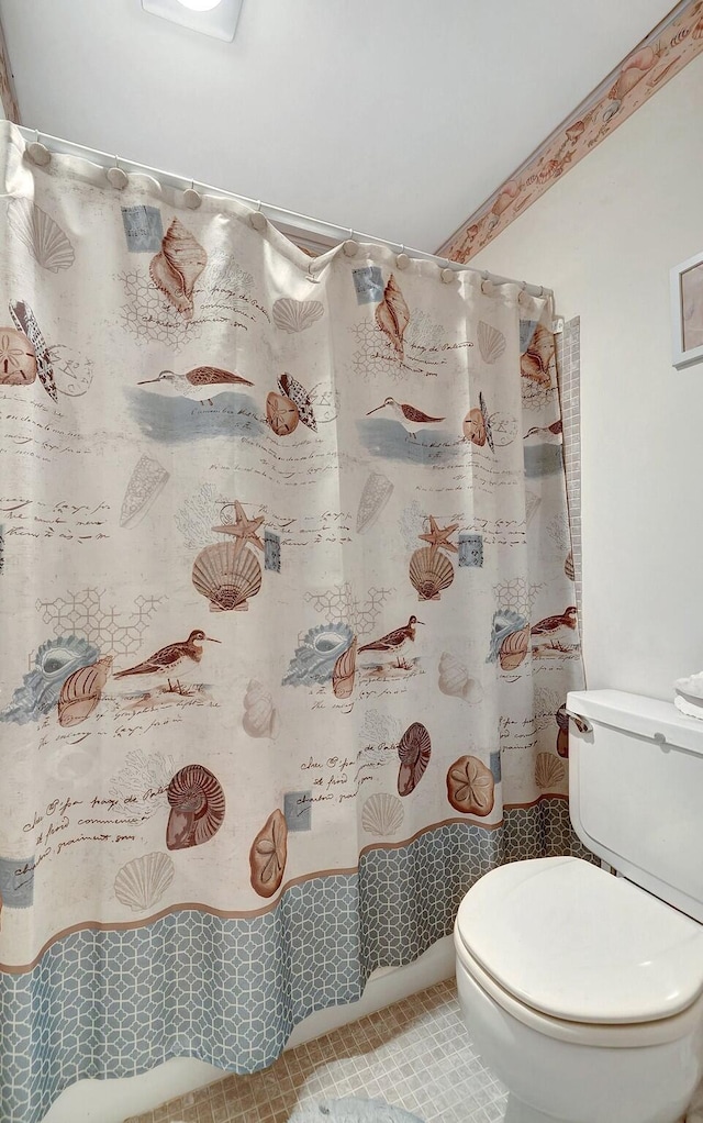 full bath featuring a shower with shower curtain, tile patterned flooring, and toilet