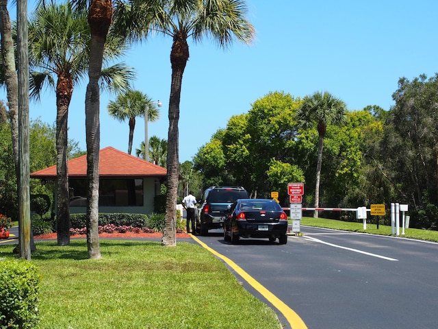 view of street featuring traffic signs and a gated entry