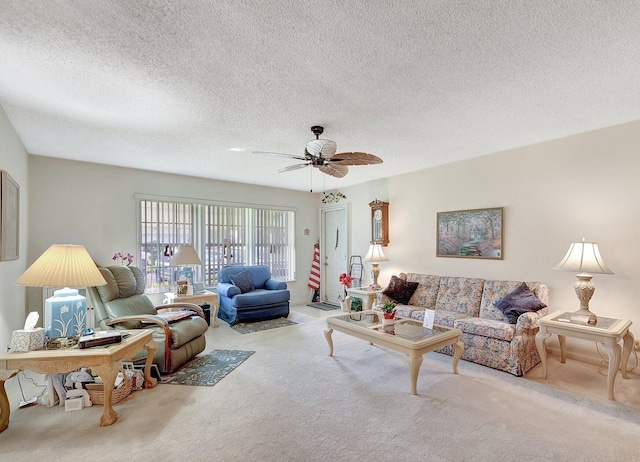 carpeted living room with a ceiling fan and a textured ceiling