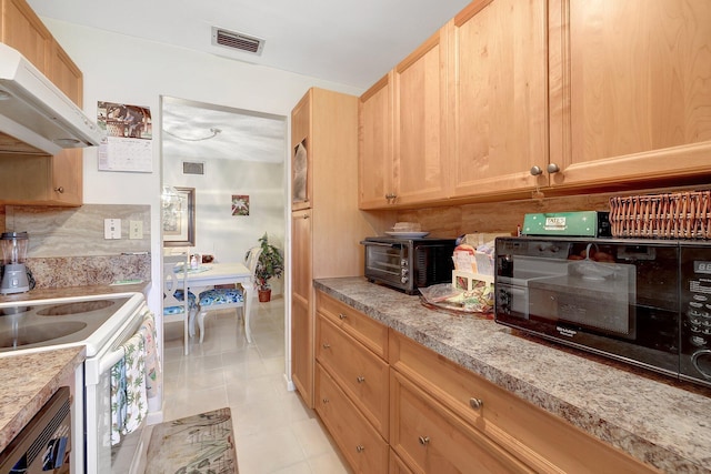 kitchen with visible vents, under cabinet range hood, black appliances, and light brown cabinetry