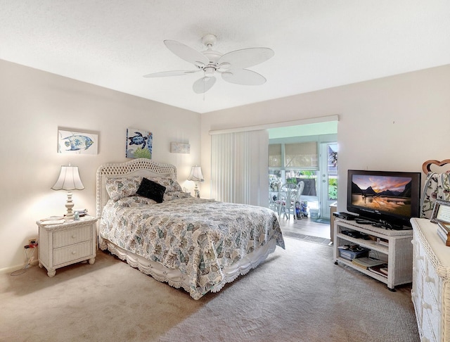 carpeted bedroom with a ceiling fan and access to exterior