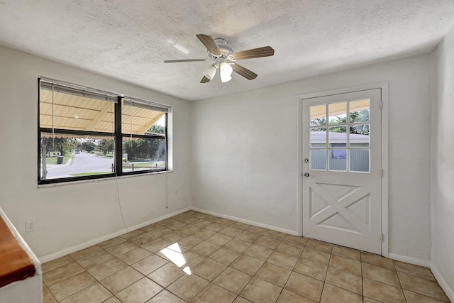 doorway to outside featuring a wealth of natural light, ceiling fan, and light tile patterned flooring