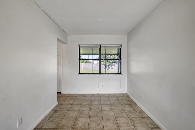 unfurnished room featuring light tile patterned floors