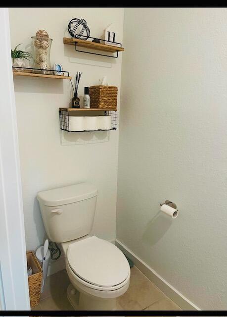 bathroom with tile patterned flooring and toilet