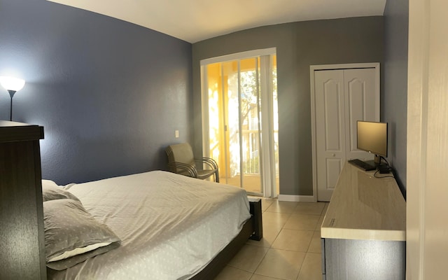 tiled bedroom featuring a closet