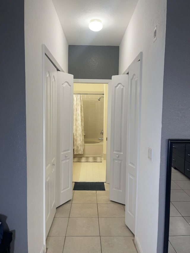 hall featuring light tile patterned floors