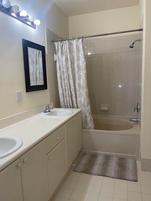 bathroom with tile patterned floors, shower / bath combo with shower curtain, and vanity