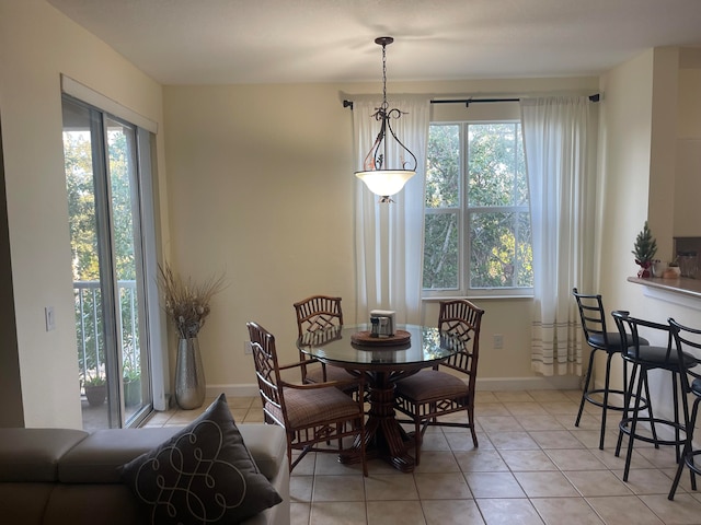 dining room featuring plenty of natural light and light tile patterned flooring