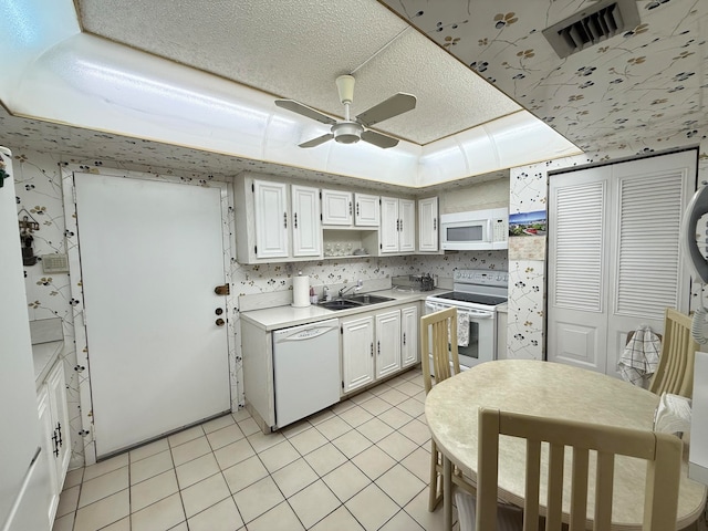 kitchen featuring light tile patterned floors, white appliances, white cabinetry, and ceiling fan