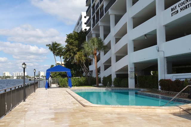 view of swimming pool featuring a water view