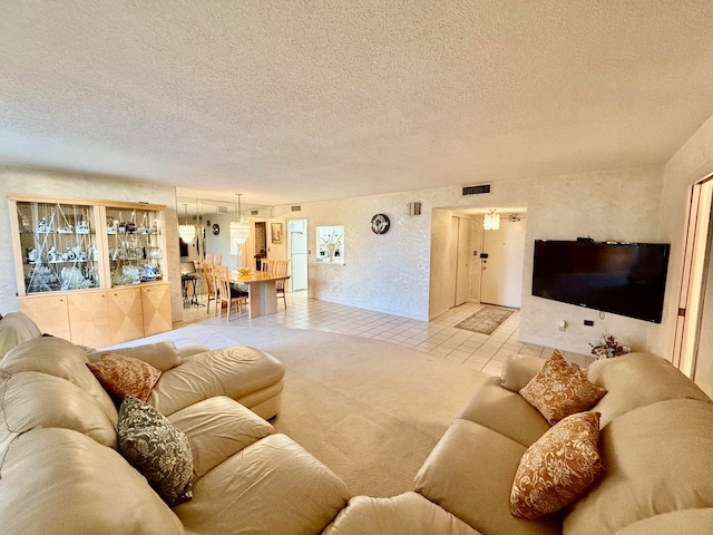 living room with light tile patterned flooring and a textured ceiling