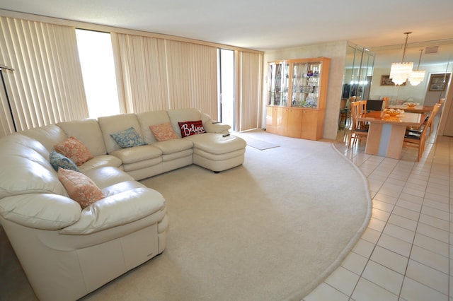 living room featuring light tile patterned floors and a notable chandelier