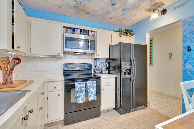 kitchen with black appliances, white cabinets, and a textured ceiling