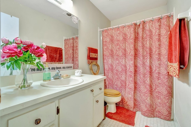 bathroom featuring tile patterned floors, vanity, and toilet