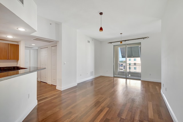 unfurnished living room with dark hardwood / wood-style floors