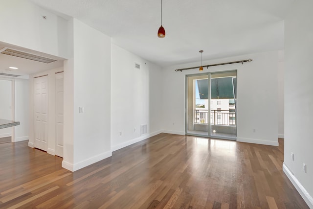 unfurnished room featuring dark hardwood / wood-style flooring