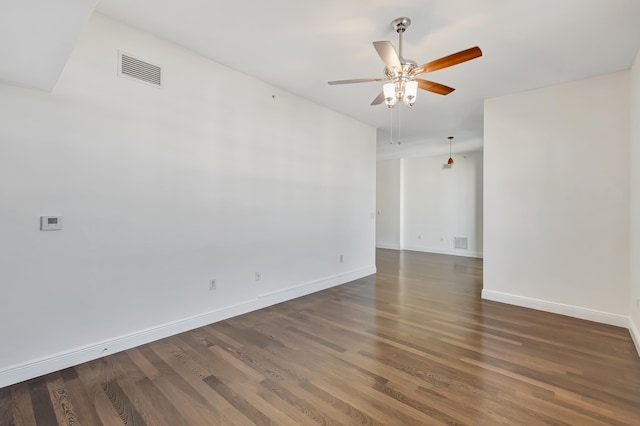 spare room with ceiling fan and dark hardwood / wood-style flooring