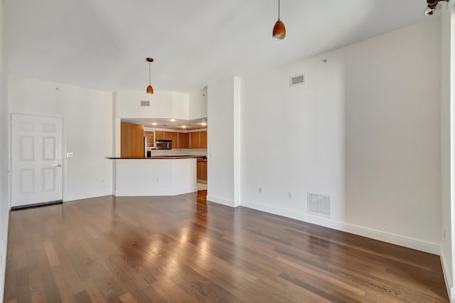 unfurnished living room with dark hardwood / wood-style floors