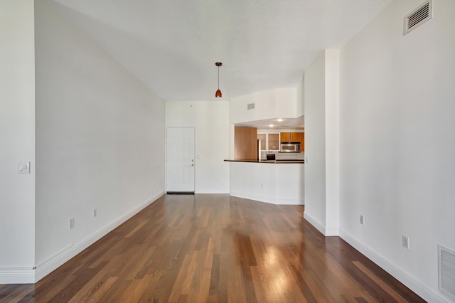 unfurnished living room with dark hardwood / wood-style floors