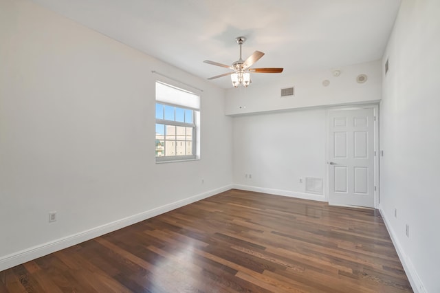 spare room featuring ceiling fan and dark hardwood / wood-style floors