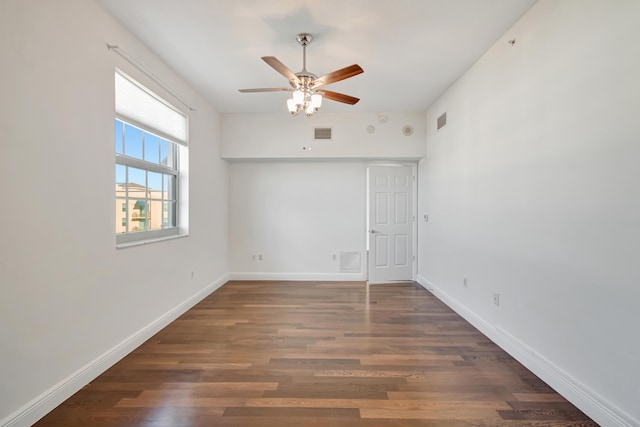 spare room featuring ceiling fan and dark wood-type flooring